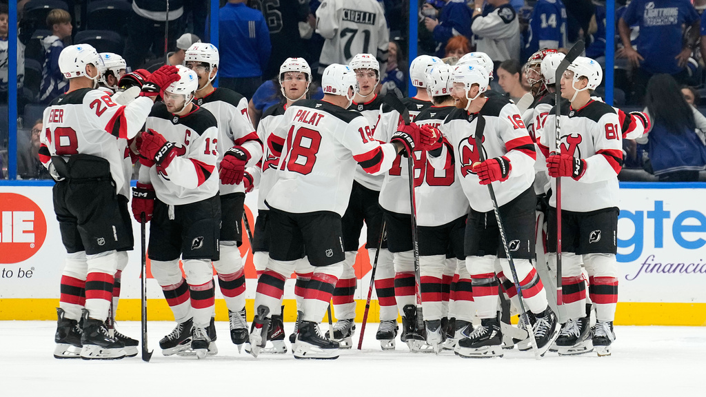 New Jersey Devils players celebratre after defeating the Tampa Bay Lightning during an NHL hockey game Saturday, Oct. 11, 2025, in Tampa, Fla. (AP Photo/Chris O'Meara)