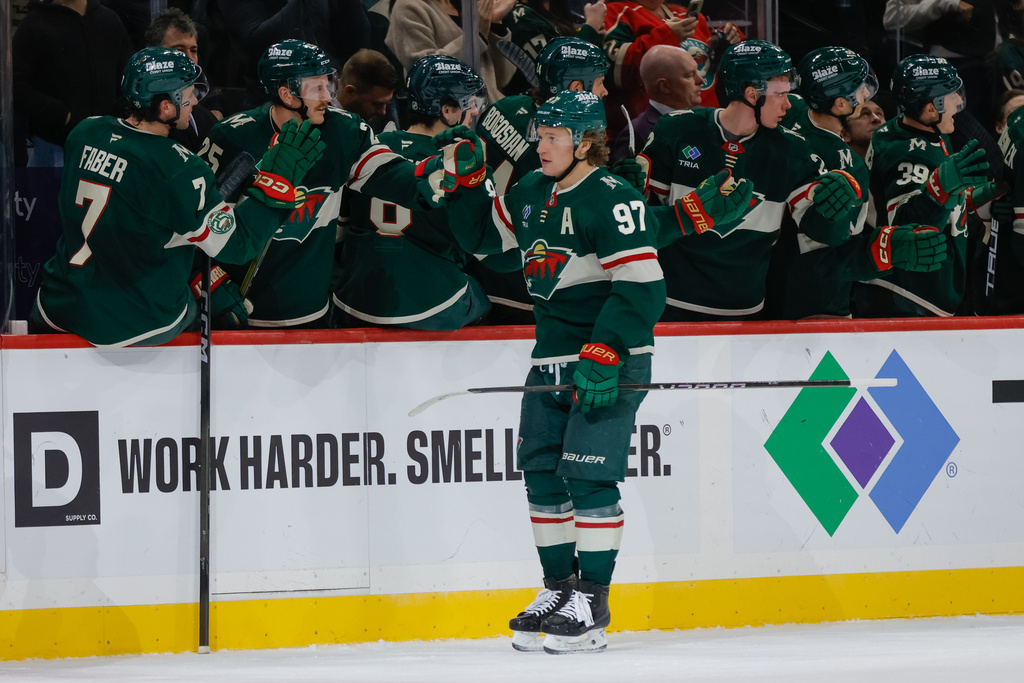 Minnesota Wild left wing Kirill Kaprizov (97) is congratulated by teammates after scoring his second goal of the game during the second period of an NHL hockey game against the Colorado Avalanche, Friday, Nov. 28, 2025, in St. Paul, Minn. (AP Photo/Bailey Hillesheim)