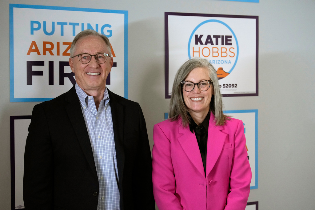 Arizona Democratic Gov. Katie Hobbs, right, poses for a photograph with her running mate for Lieutenant Governor John Giles, the former Republican Mesa, Ariz., mayor, Monday, Aug. 10, 2026, in Phoenix. (AP Photo/Ross D. Franklin)