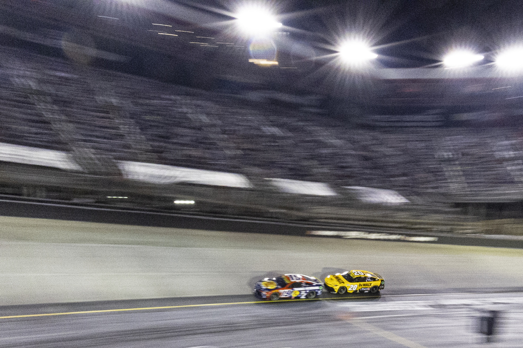 Christopher Bell (20) chases after Chase Briscoe (19) during a NASCAR Cup Series auto race, Saturday, Sept. 13, 2025, in Bristol, Tenn. (AP Photo/Wade Payne)