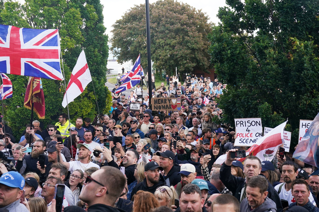 People gather to protest outside Southampton police station, Southampton, England, Tuesday June 2, 2026, after the fatal stabbing of Henry Nowak, a British teenager who was handcuffed despite claiming he was the crime victim. (Gareth Fuller/PA via AP)