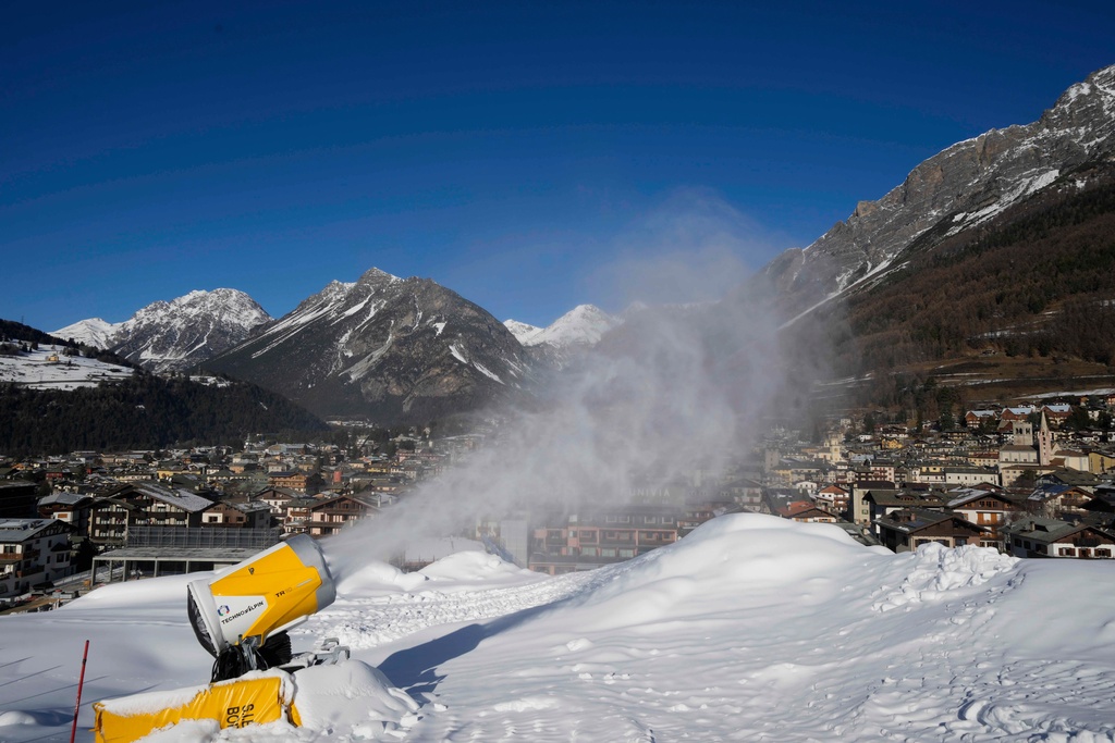 FILE - A snow gun sprays artificial snow at the Stelvio Ski Center, venue for the alpine ski and ski mountaineering disciplines at the 2026 Milan Cortina Winter Olympics, in Bormio, Italy, Jan. 16, 2025. (AP Photo/Luca Bruno, File)