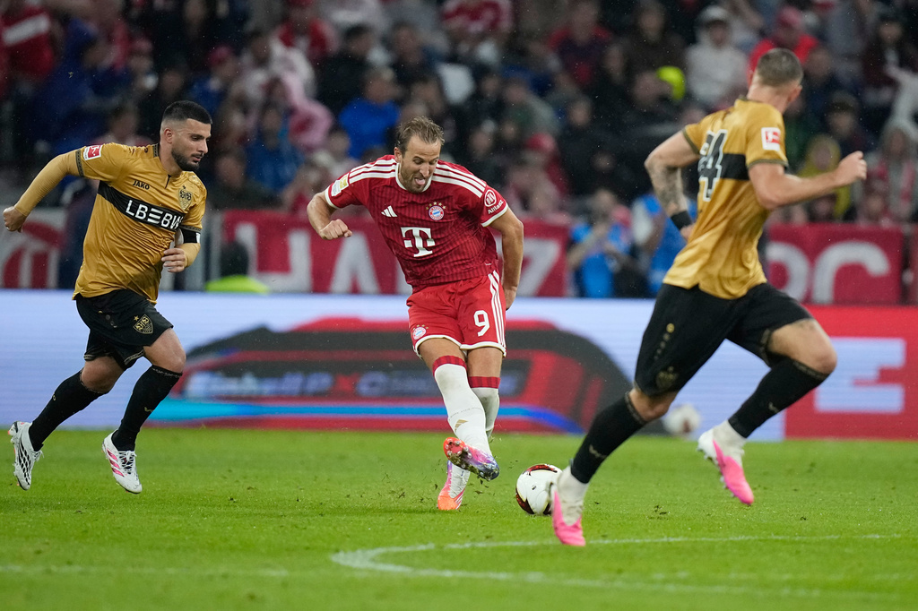 Bayern's Harry Kane, centre, passes the ball during the Bundesliga soccer match between Bayern Munich and VfB Stuttgart in Munich, Germany, Friday, Aug. 28, 2026. (AP Photo/Matthias Schrader)