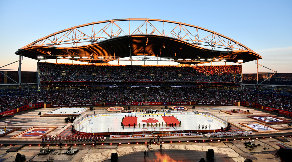 A Canadian flag is unfurled at Princess Auto Stadium before the NHL Heritage Classic hockey game between the Winnipeg Jets and the Montreal Canadiens in Winnipeg, Manitoba, Sunday, Oct. 25, 2026. (Fred Greenslade/The Canadian Press via AP)