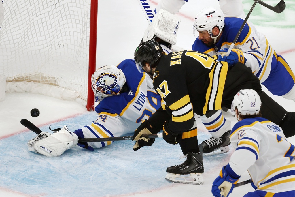 Boston Bruins' Mark Kastelic (47) scores on Buffalo Sabres' Alex Lyon (34) during the second period of an NHL hockey game, Thursday, Oct. 30, 2025, in Boston. (AP Photo/Michael Dwyer)