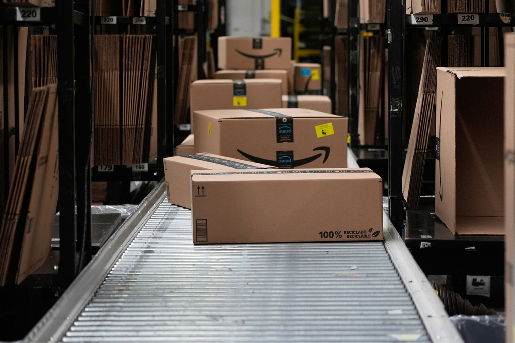 FILE - Boxes sit on a conveyor belt at an Amazon storage warehouse in Tepotzotlan, Mexico, May 22, 2025. (AP Photo/Marco Ugarte, File)