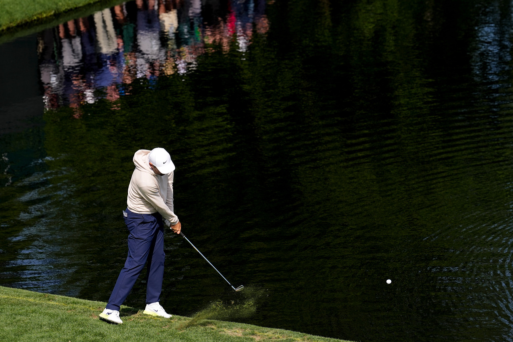 Scottie Scheffler skips a ball on the 16th hole during a practice round ahead of the Masters golf tournament at the Augusta National Golf Club, Wednesday, April 8, 2026, in Augusta, Ga. (AP Photo/David J. Phillip)