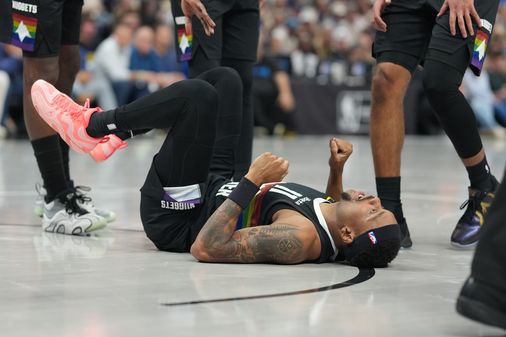 Denver Nuggets guard Bruce Brown reacts after getting hurt while driving to the basket in the second half of an NBA basketball game against the San Antonio Spurs, Saturday, April 4, 2026, in Denver. (AP Photo/David Zalubowski)