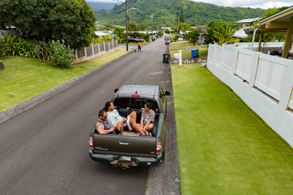 Kimeona Kane rides with his nephew, Gabriel Shimaoka, and niece, Genesis Shimaoka, in the bed of his pickup truck, Friday, July 17, 2026, in Kailua, Hawaii. (AP Photo/Mengshin Lin)