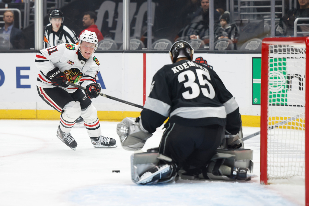 Chicago Blackhawks center Oliver Moore (11) shoots against Los Angeles Kings goaltender Darcy Kuemper (35) during the first period of an NHL hockey game Saturday, Dec. 6, 2025, in Los Angeles. (AP Photo/Caroline Brehman)