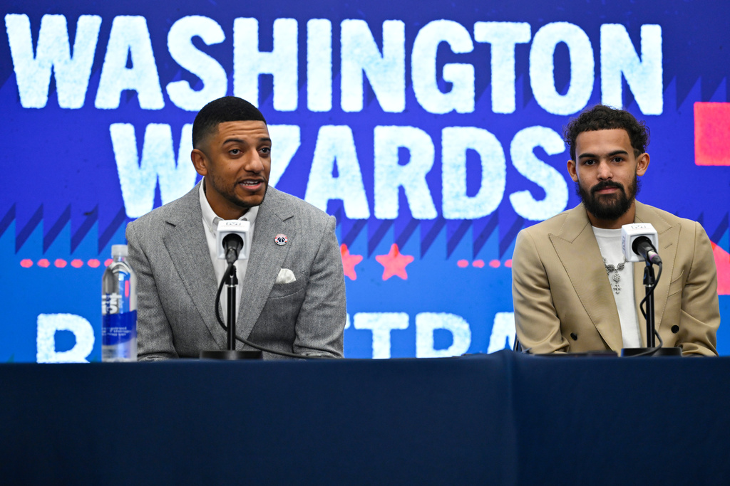 Washington Wizards general manager Will Dawkins, left, introduces newly acquired point guard Trae Young, right, at a news conference before an NBA basketball game against the New Orleans Pelicans, Friday, Jan. 9, 2026, in Washington. (AP Photo/John McDonnell)