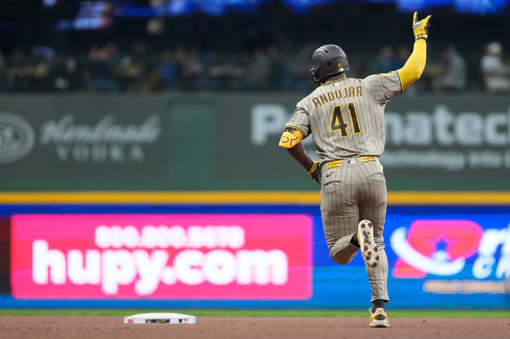 San Diego Padres' Miguel Andujar gestures as he rounds the bases after hitting a solo home run during the sixth inning of a baseball game against the Milwaukee Brewers, Tuesday, May 12, 2026, in Milwaukee. (AP Photo/Aaron Gash)