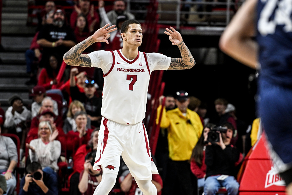 Arkansas forward Trevon Brazile (7) reacts after hitting a three point shot against Queens during the first half of an NCAA college basketball game Tuesday, Dec. 16, 2025, in Fayetteville, Ark. (AP Photo/Michael Woods)