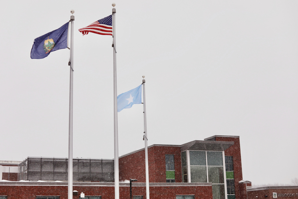 A Somali flag flies alongside the United States and Vermont flags outside the Winooski School District building, Wednesday, Dec. 10, 2025, in Winooski, Vt. (AP Photo/Amanda Swinhart)