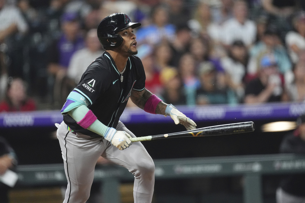Arizona Diamondbacks' Ketel Marte singles against Colorado Rockies pitcher Tanner Gordon in the sixth inning of a baseball game Friday, Aug. 15, 2025, in Denver. (AP Photo/David Zalubowski)