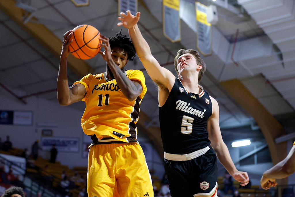 Western Michigan guard Justice Williams (11) and Miami (Ohio) guard Peter Suder (5) vie for a rebound during the first half of an NCAA college basketball game, Friday, Feb. 27, 2026, in Kalamazoo, Mich. (AP Photo/Al Goldis)