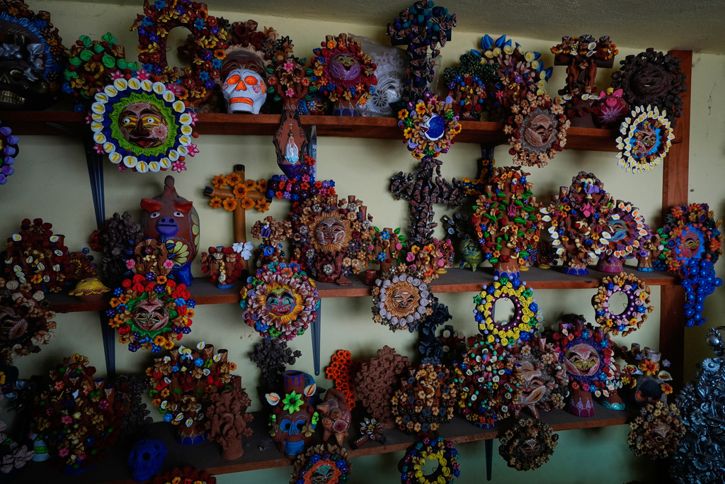 Finished pieces ready for sale are displayed inside the atelier of Mexican artisan Hilario Hernández in Metepec, Mexico, Thursday, Oct. 9, 2025. (AP Photo/Fernando Llano)