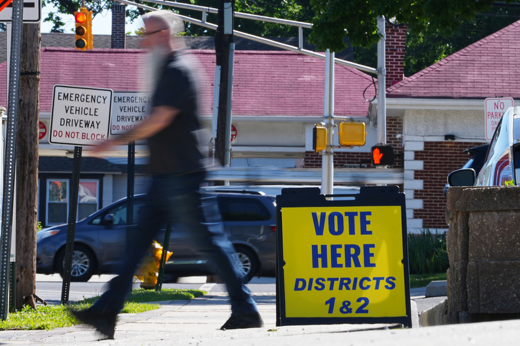 A person walks from a polling place for the New Jersey primary election in Oaklyn, N.J., Tuesday, June 2, 2026. (AP Photo/Matt Rourke)