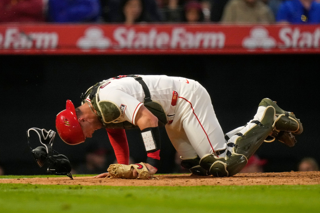 Los Angeles Angels catcher Logan O'Hoppe crawls around home plate after being injured on a pitch to Los Angeles Dodgers' Will Smith during the sixth inning of a baseball game Saturday, May 16, 2026, in Anaheim, Calif. (AP Photo/Mark J. Terrill)