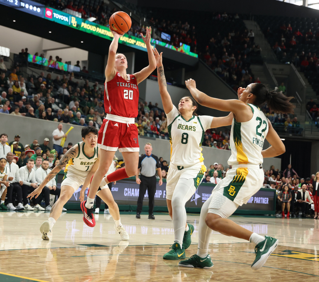 Texas Tech guard Bailey Maupin (20) goes up to score over Baylor forward Kayla Nelms (8) and forward Bella Fontleroy, right, in the first half of an NCAA college basketball game, Sunday, Dec. 21, 2025, in Waco, Texas. (Rod Aydelotte/Waco Tribune-Herald via AP)