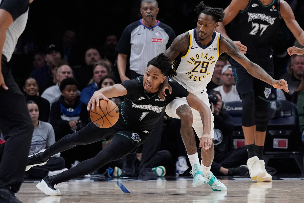 Minnesota Timberwolves guard Terrence Shannon Jr. (1) reaches for the ball as Indiana Pacers guard Quenton Jackson (29) defends during the first half of an NBA basketball game, Sunday, Oct. 26, 2025, in Minneapolis. (AP Photo/Abbie Parr)