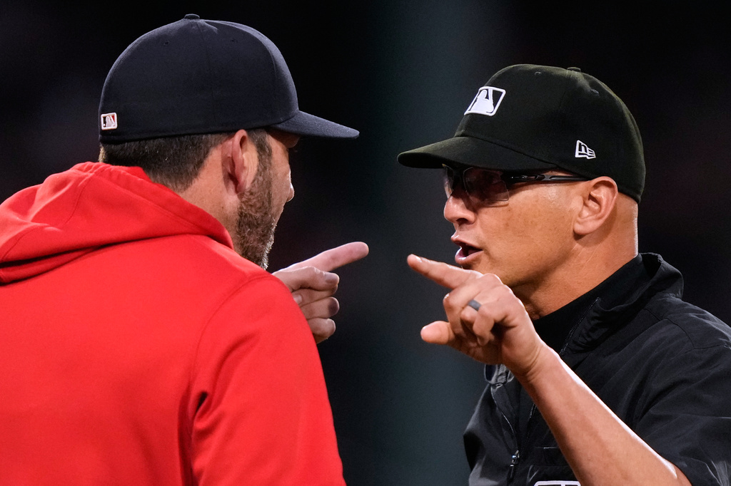 Boston Red Sox interim manager Chad Tracy, left, argues with umpire Vic Carapazza following a bench clearing altercation during the fourth inning of a baseball game against the Washington Nationals, Tuesday, June 30, 2026, in Boston. (AP Photo/Charles Krupa)
