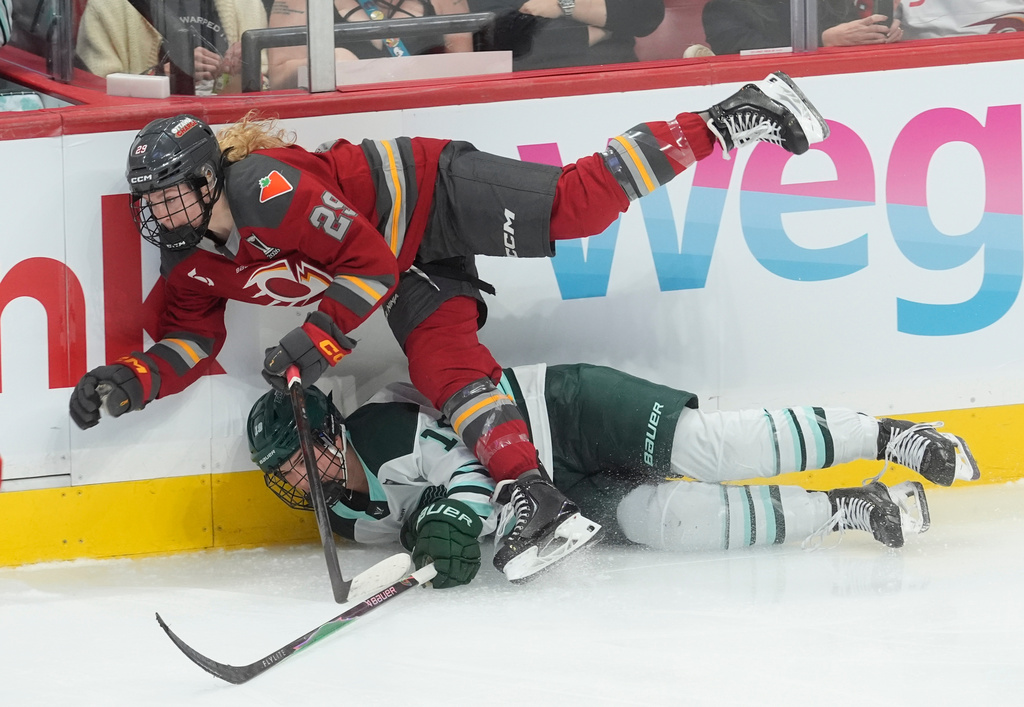 Ottawa Charge's Peyton Hemp (29) collides with Boston Fleet's Abby Newhook (19) during the third period of an PWHL hockey playoff game in Ottawa, Ontario, Friday, May 8, 2026. (Adrian Wyld/The Canadian Press via AP)
