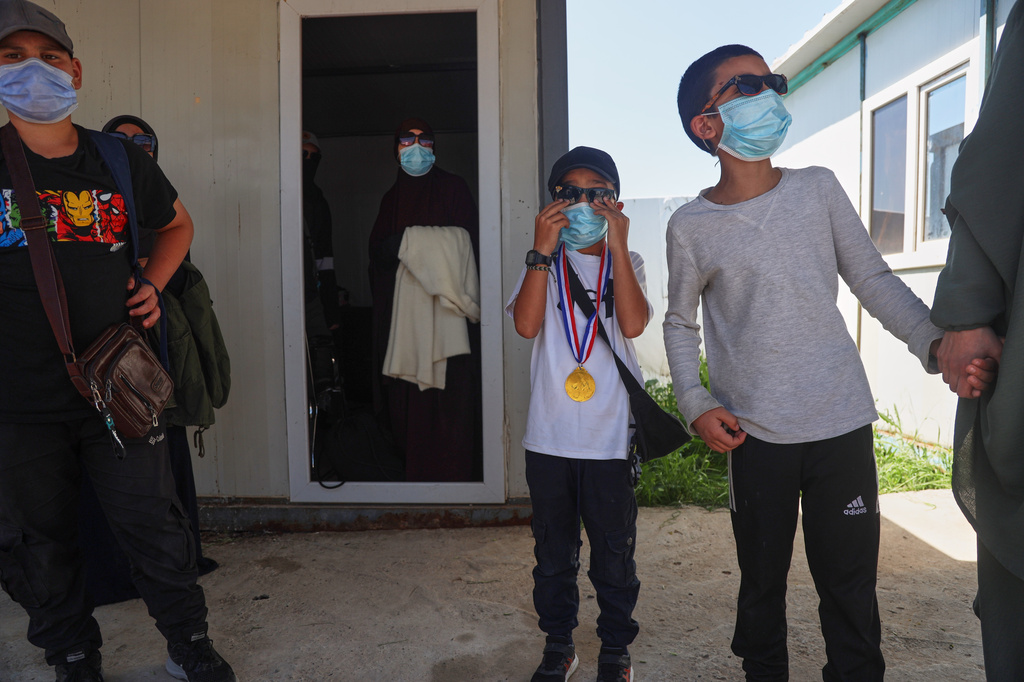 Members of Australian families at Roj Camp in eastern Syria, housing people with alleged ties to Islamic State militants, prepare to leave for Damascus as part of a second repatriation effort by Syrian authorities, at Roj Camp in eastern Syria, Friday, April 24, 2026. (AP Photo/Baderkhan Ahmad)