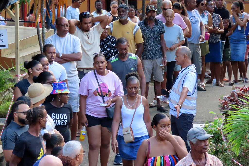 People line up to cast their votes at Beau Vallon Secondary School in Beau Vallon, Seychelles, on Saturday, Sep. 27, 2025. (AP Photo/Emilie Chetty)