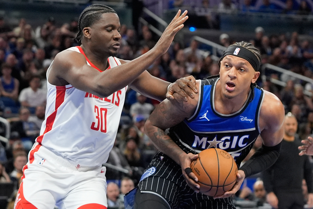 Orlando Magic forward Paolo Banchero, right, looks for a shot against Houston Rockets center Clint Capela (30) during the first half of an NBA basketball game, Thursday, Feb. 26, 2026, in Orlando, Fla. (AP Photo/John Raoux)