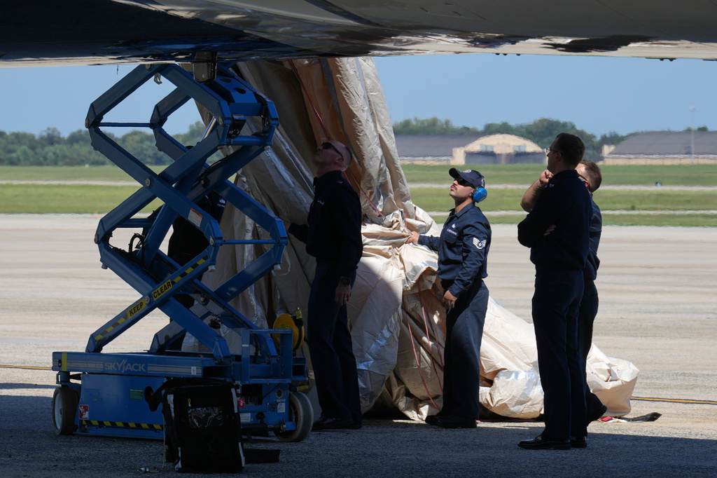 U.S> Air Force personnel work after an emergency inflatable slide deployed before President Donald Trump arrived to board at Joint Base Andrews, Md., Wednesday, Sept. 9, 2026. (AP Photo/Jacquelyn Martin)