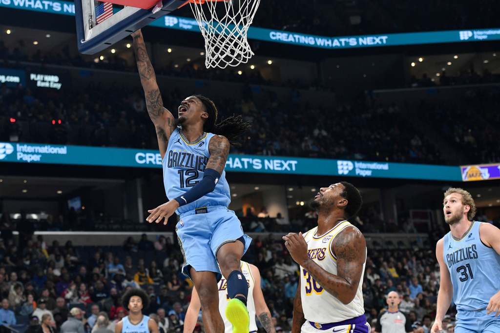 Memphis Grizzlies guard Ja Morant (12) shoots over Los Angeles Lakers guard Marcus Smart (36) in the first half of an NBA Cup basketball game Friday, Oct. 31, 2025, in Memphis, Tenn. (AP Photo/Brandon Dill)