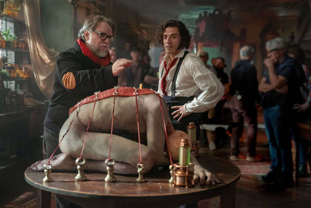This image released by Netflix shows director Guillermo del Toro, left, and Oscar Isaac on the set of "Frankenstein." (Ken Woroner/Netflix via AP)
