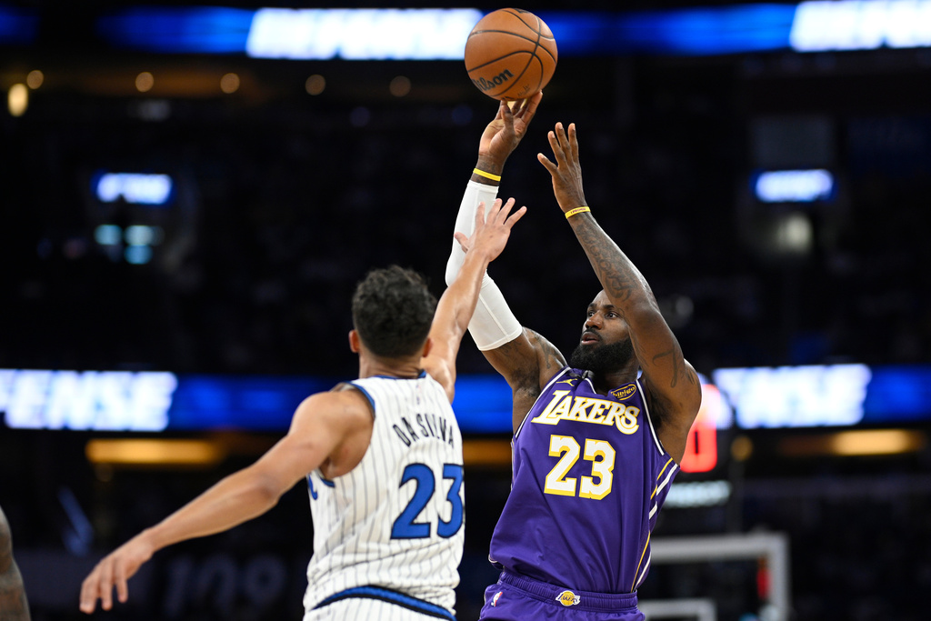 Los Angeles Lakers forward LeBron James (23) goes up to shoot as Orlando Magic forward Tristan da Silva, left, defends during the first half of an NBA basketball game, Saturday, March 21, 2026, in Orlando, Fla. (AP Photo/Phelan M. Ebenhack)
