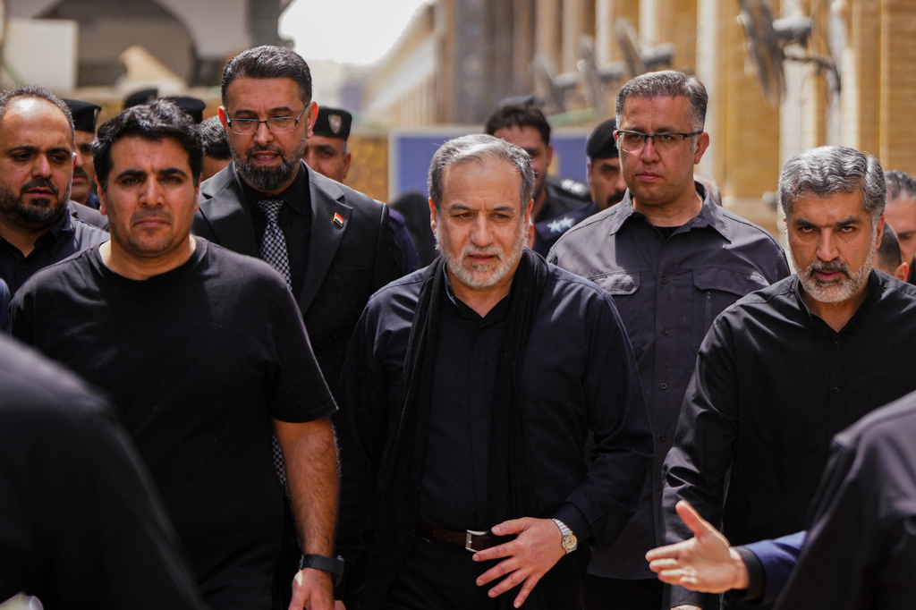 Iranian Foreign Minister Abbas Araghchi, center, is surrounded by security personnel as he walks during the Arbaeen commemoration in Najaf, Iraq, Monday, Aug. 3, 2026. (AP Photo/Anmar Khalil)