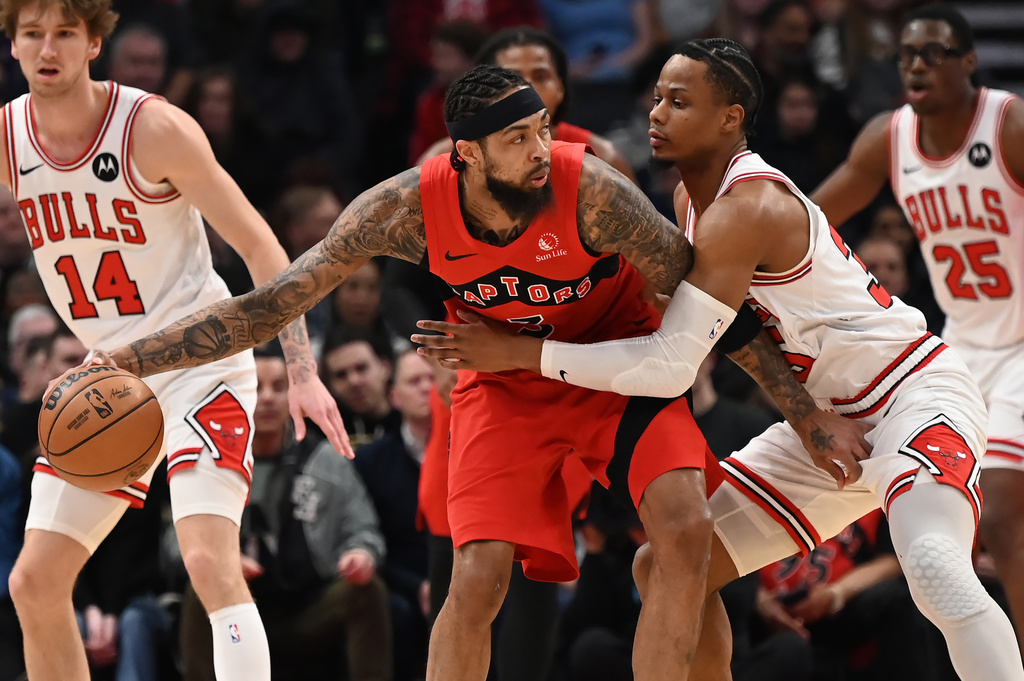 Toronto Raptors' Brandon Ingram (3) protects the ball from Chicago Bulls' Isaac Okoro (35) during first half NBA basketball game action in Toronto on Thursday, Feb. 5, 2026. (Jon Blacker/The Canadian Press via AP)