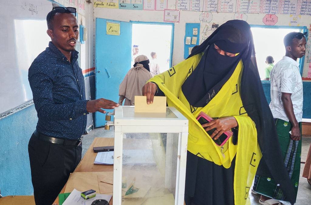 A woman casts her vote at a polling station during early voting in the presidential elections, in Mouloud, Djibouti, Friday, April 10, 2026. (AP Photo/Guirreh Moumin)