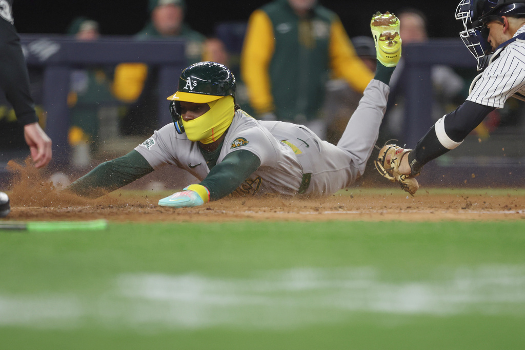 Athletics' Lawrence Butler slides home to score during the fourth inning of a baseball game against the New York Yankees, Wednesday, April 8, 2026, in New York. (AP Photo/Heather Khalifa)