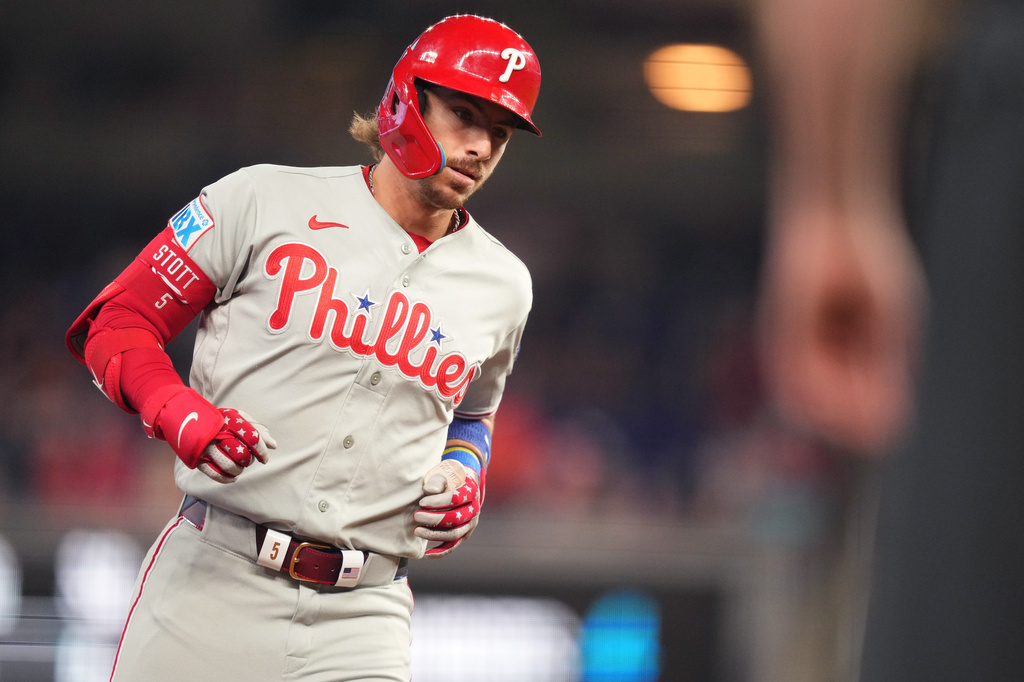 Philadelphia Phillies' Bryson Stott rounds third base after hitting a three-run home run against the Miami Marlins in the first inning of a baseball game, Sunday, May 3, 2026, in Miami. (AP Photo/Jim Rassol)