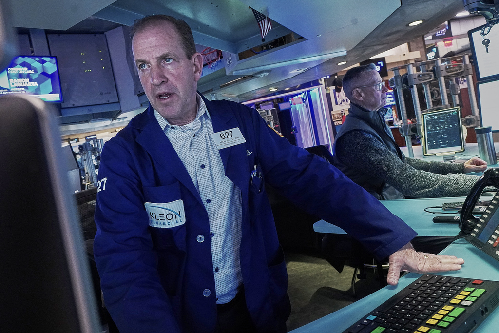 Traders Michael Smyth, left, and Neal Catania work on the floor of the New York Stock Exchange, Tuesday, Feb. 3, 2026. (AP Photo/Richard Drew)