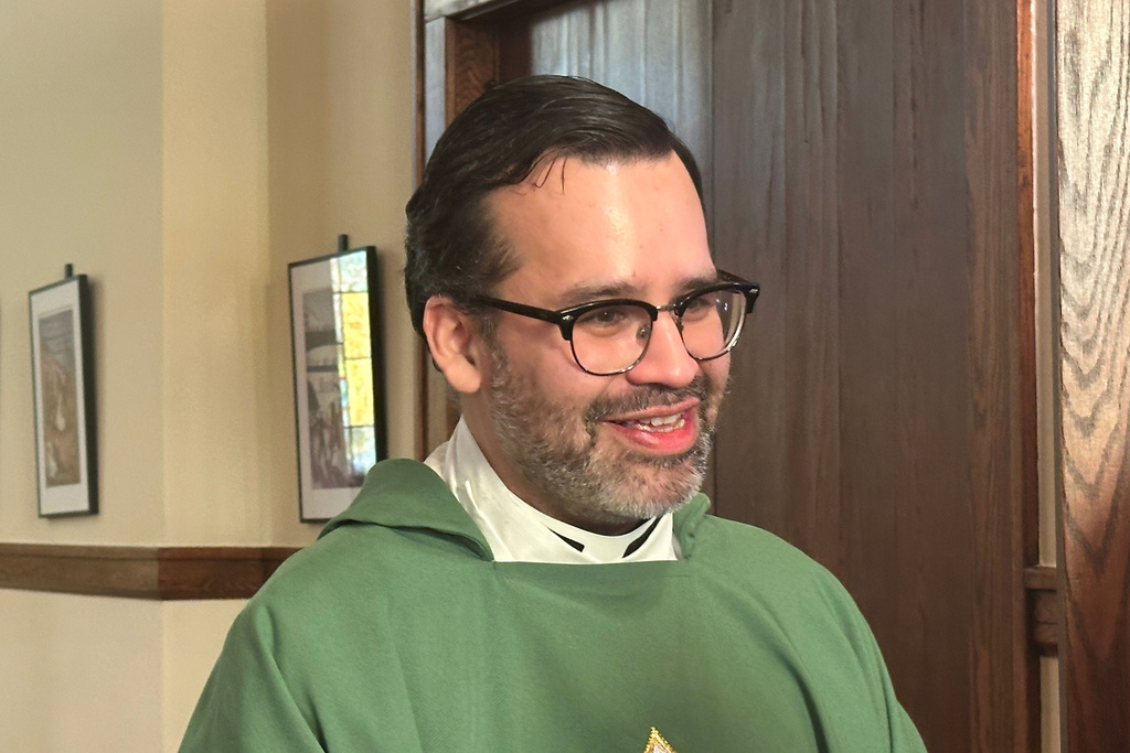 Rev. Hierald Osorto speaks to congregants after services at the St. Paul's-San Pablo Lutheran Church, in Minneapolis, Sunday, Jan. 11, 2026. (AP Photo/Rebecca Santana)