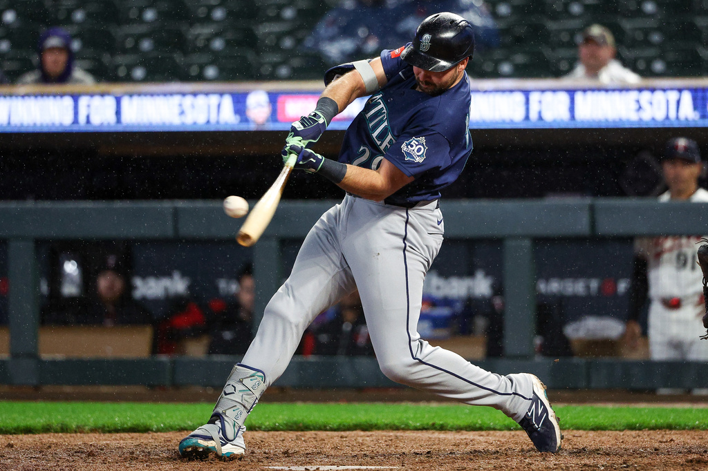 Seattle Mariners designated hitter Cal Raleigh hits a two-run home run against the Minnesota Twins during the eighth inning of a baseball game, Monday, April 27, 2026, in Minneapolis. (AP Photo/Matt Krohn)