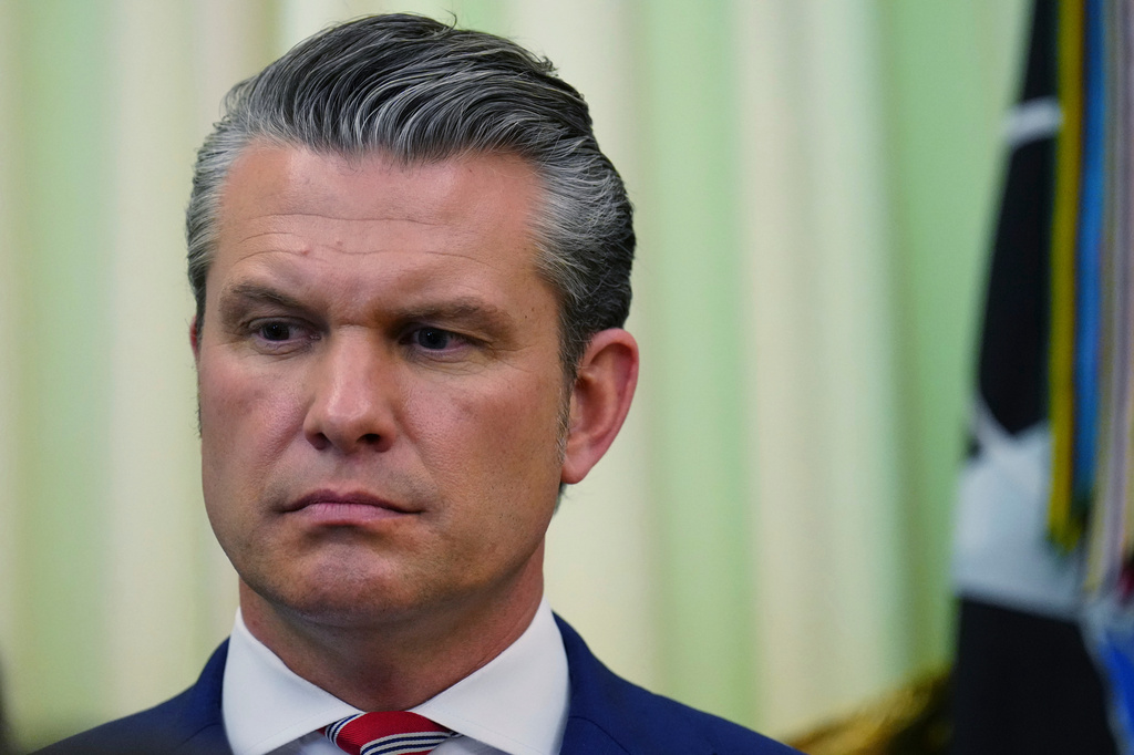 Defense Secretary Pete Hegseth listens as President Donald Trump speaks before signing a proclamation in the Oval Office at the White House, Tuesday, May 5, 2026, in Washington. (AP Photo/Jacquelyn Martin)