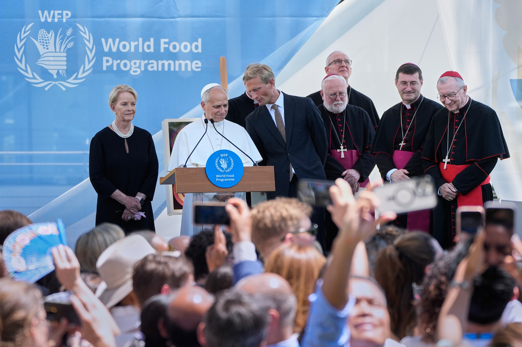 Pope Leo XIV, with, from left, former WFP Executive Director Cindy McCain, WFP Acting Executive Director Carl Skau, Archbishops Paul Richard Gallagher, Petar Rajič and Paolo Rudelli, and Vatican Secretary of State Cardinal Pietro Parolin, attends a meeting with employees of the United Nations World Food Programme in Rome, Monday, June 22, 2026. (AP Photo/Alessandra Tarantino)