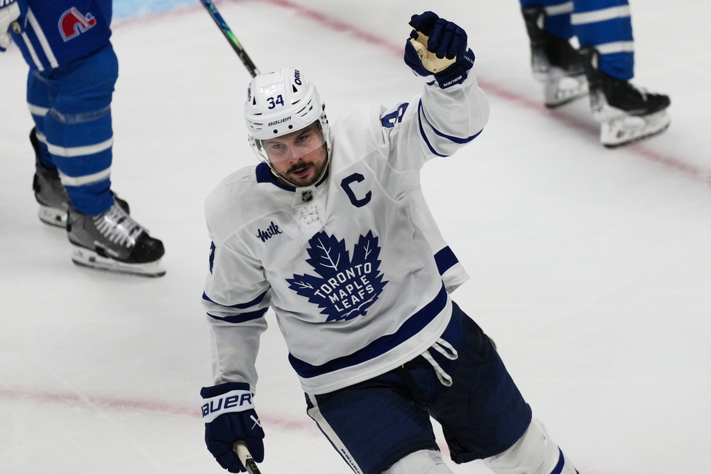 Toronto Maple Leafs center Auston Matthews celebrates after scoring a goal against the Colorado Avalanche in the third period of an NHL hockey game Monday, Jan. 12, 2026, in Denver. (AP Photo/David Zalubowski)