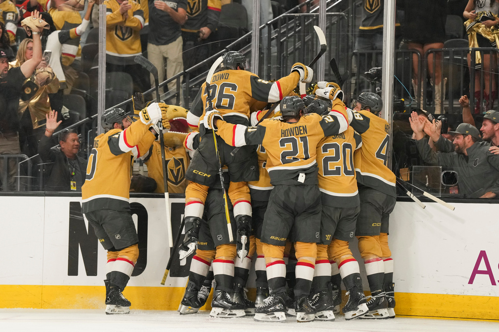 The Vegas Golden Knights celebrate defeating the Anaheim Ducks during overtime of Game 5 of a second-round NHL hockey Stanley Cup playoff series Tuesday, May 12, 2026, in Las Vegas. (AP Photo/Candice Ward)
