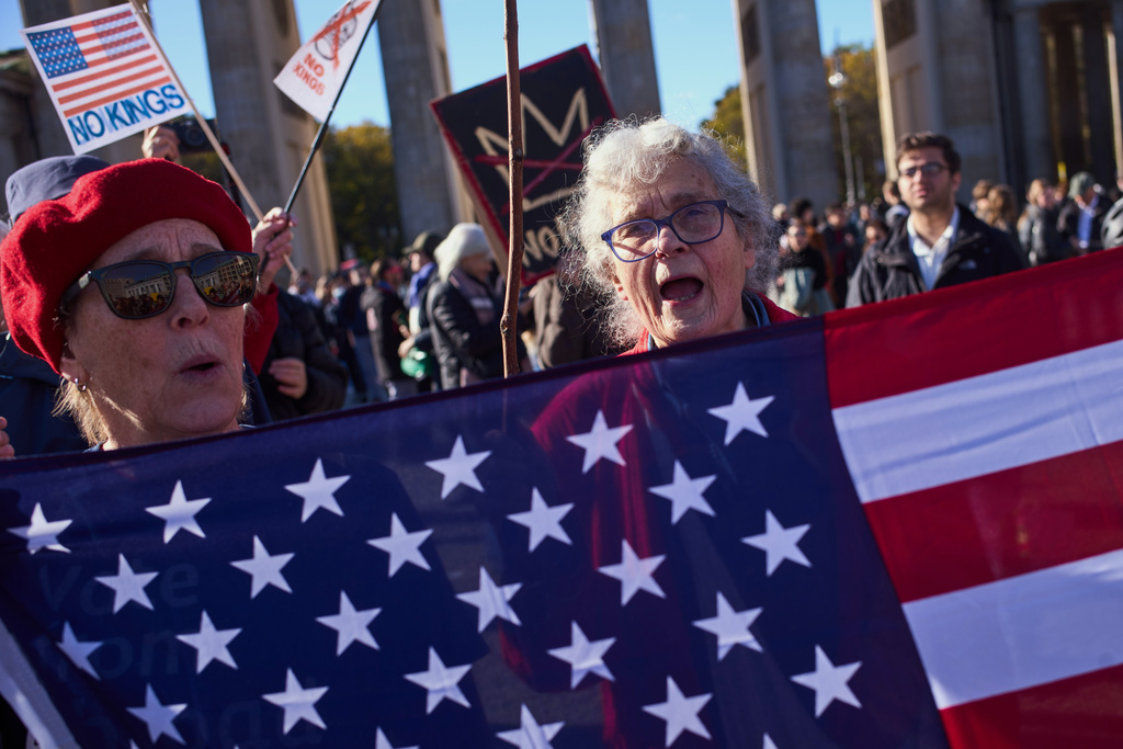 People shout slogans as they participate in a pro-democracy, anti-Trump protest outside the US embassy at the Pariser Platz square in Berlin, Saturday, Oct. 18, 2025. (AP Photo/Markus Schreiber)