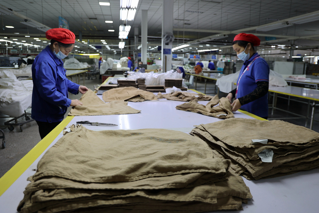 Workers labor at a textile manufacturer, in Binzhou in east China's Shandong province on Oct. 23, 2025. (Chinatopix Via AP)