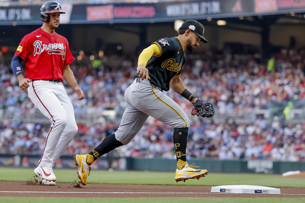 Pittsburgh Pirates third baseman Nick Gonzales, right, beats Atlanta Braves' Matt Olson, left, to third for a force out for the final out of the first inning of a baseball game, Friday, June 5, 2026, in Atlanta. (AP Photo/Erik S. Lesser)