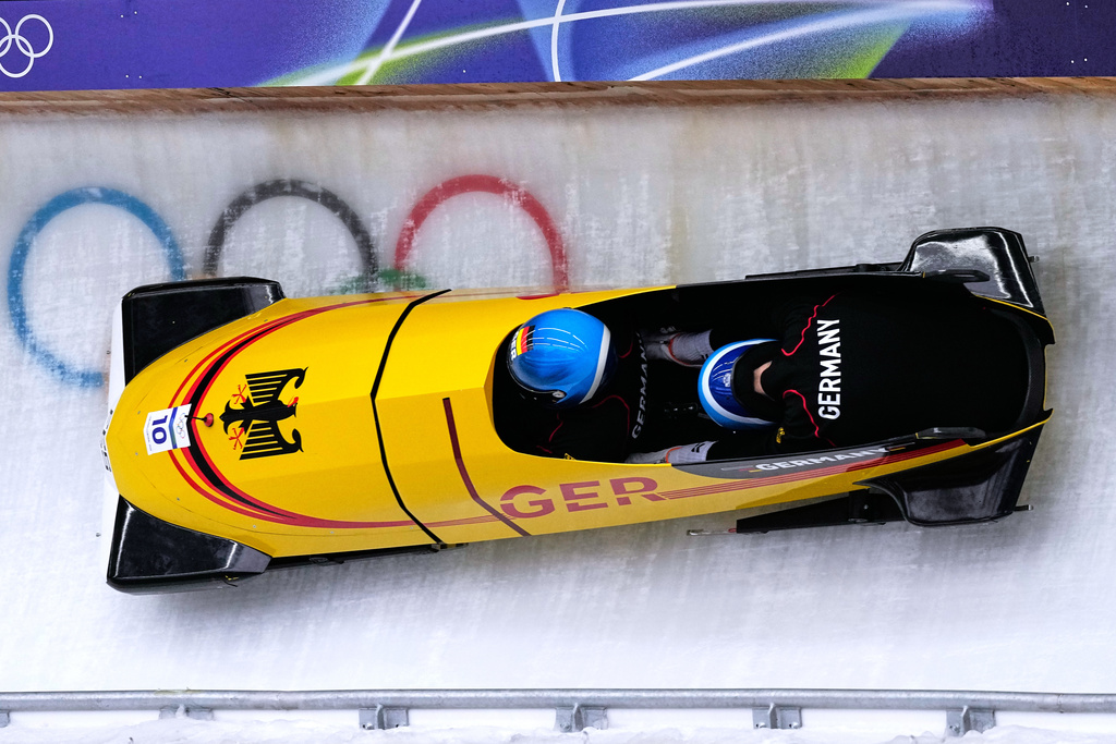 Germany's Francesco Friedrich, left, slides down the track during a two man bobsled training session at the 2026 Winter Olympics, in Cortina d'Ampezzo, Italy, Saturday, Feb. 14, 2026. (AP Photo/Aijaz Rahi)